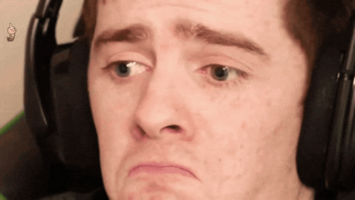 a man wearing headphones is making a funny face