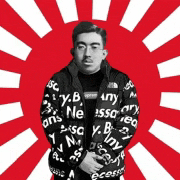 a man wearing a supreme jacket is standing in front of a red and white sun