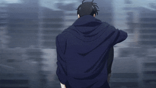 a man in a blue hoodie is walking in the dark