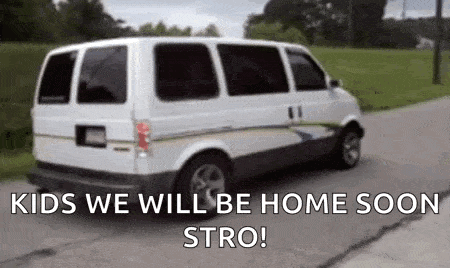 a white van is driving down a street with the words `` kids we will be home soon stro '' .