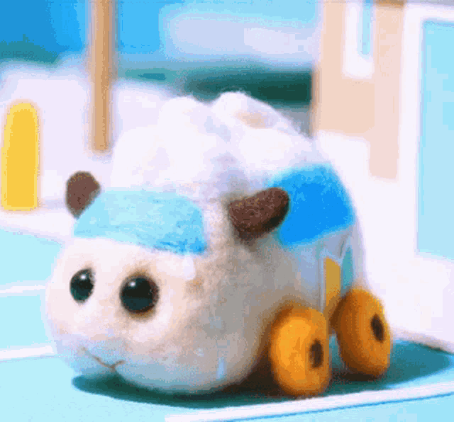 a stuffed animal that looks like a sheep is sitting on a table .