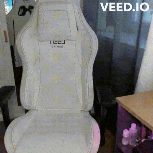 a white teej gaming chair is sitting on a table