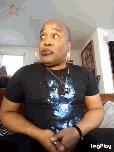 a man wearing a black t-shirt with a blue cat on it