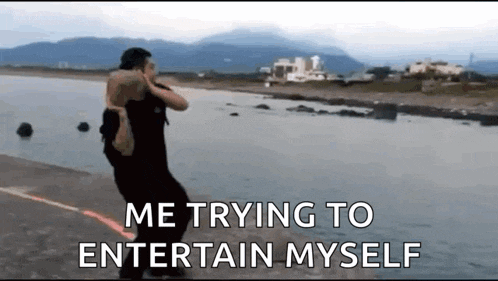 a man is carrying another man on his shoulders while walking on the beach .