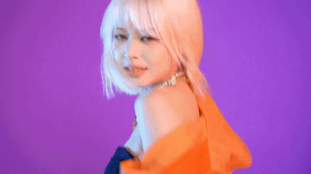 a woman with blonde hair is wearing an orange jacket and a choker .