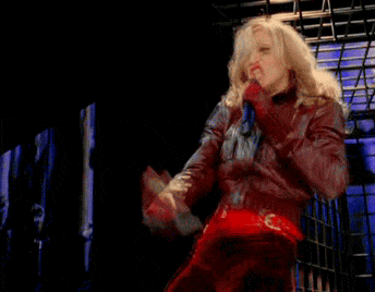 a woman in a red leather jacket is giving the middle finger to the camera