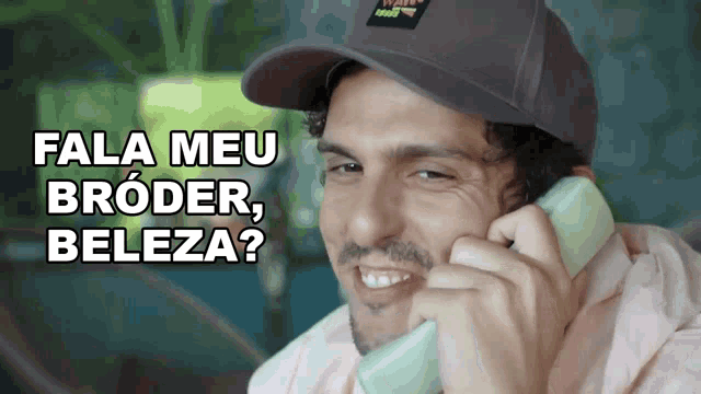 a man wearing a hat is talking on a phone with the words fala meu broder beleza above him