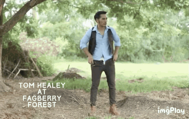 a man standing in a field with the words tom healey at fagberry forest on the bottom