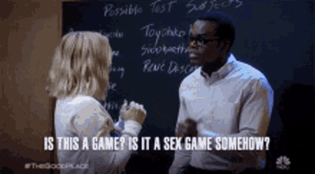 a man and a woman are standing in front of a blackboard and talking about sex games