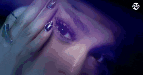a close up of a woman 's face with the letters rs on the bottom
