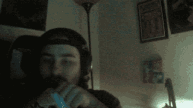 a man with a beard is smoking a cigarette