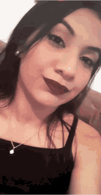 a woman with red lipstick and a nose ring