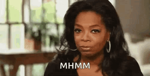 oprah winfrey is making a funny face while sitting in front of a window .