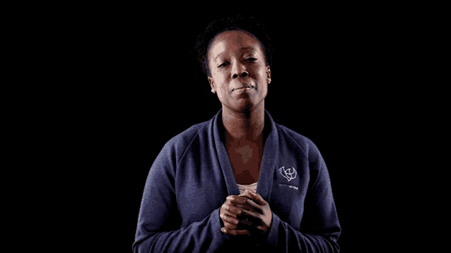 a woman wearing a blue sweater with a logo on the front that says ' freedom '