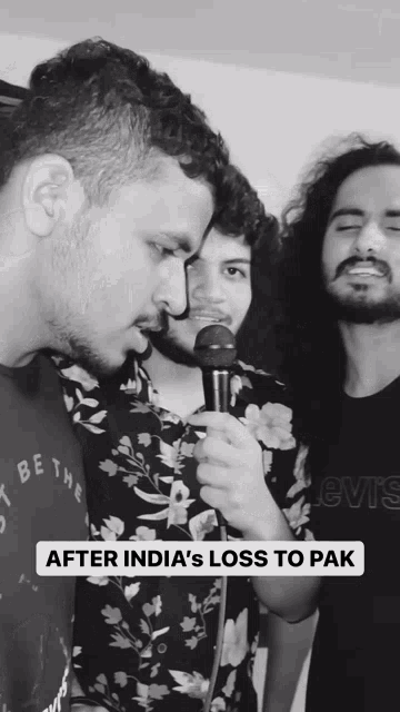 a man singing into a microphone with the words after india 's loss to pak