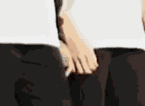 a close up of a person 's hands on a person 's pants .