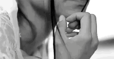 a black and white photo of a woman holding a stethoscope to her neck .