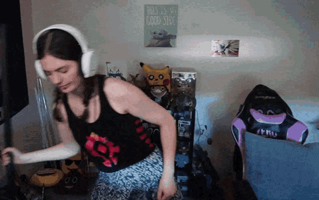 a woman dancing in front of a sign that says " this is my good side "