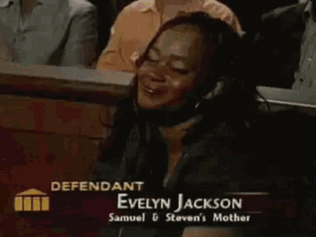 defendant evelyn jackson sits in a courtroom with her eyes closed