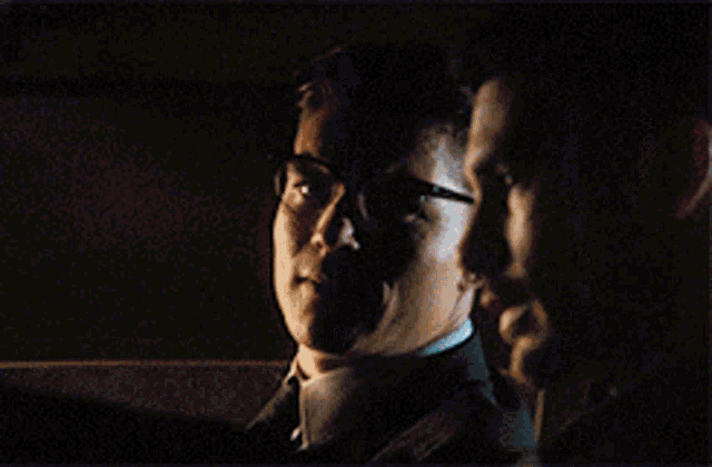 a man with glasses says dad shot peaches in a dark room