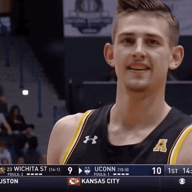 a uconn basketball player smiles during a game against kansas city