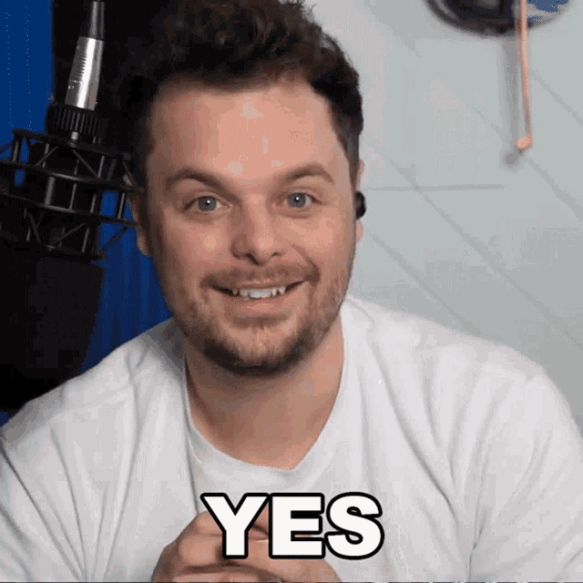 a man in a white shirt has the word yes on his chest