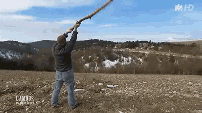 a man is holding a stick up in the air with the words l' amour on the bottom right