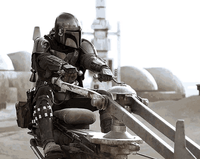 a man wearing a helmet is riding a motorcycle in the desert