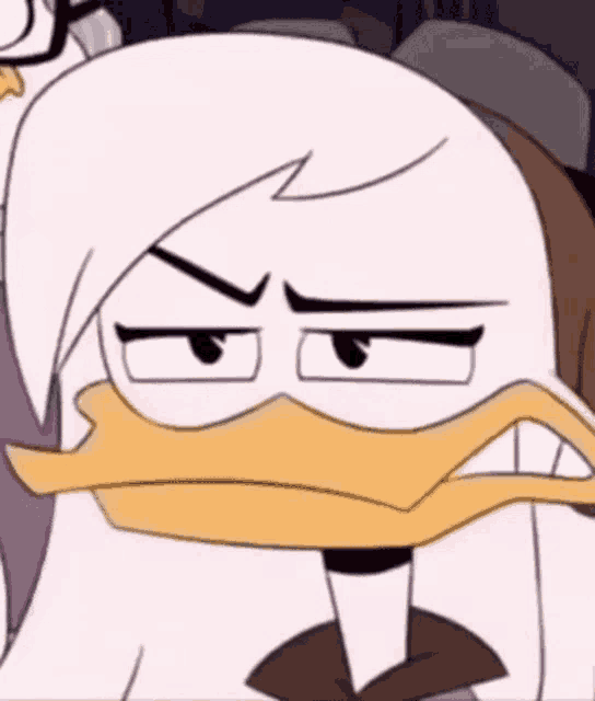 a close up of a cartoon duck with an angry look on its face .