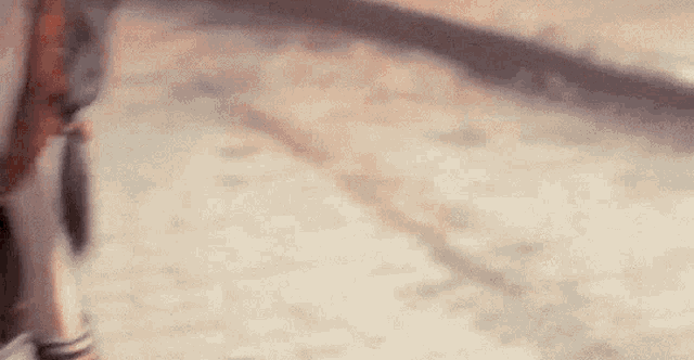 a blurred image of a person walking down a sidewalk