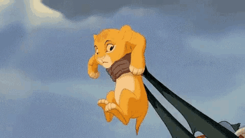 a cartoon lion is being held by a person with arabic writing