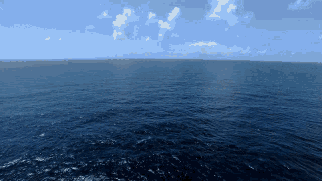 a large body of water with clouds in the sky