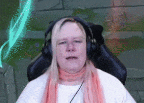 a woman wearing headphones and a scarf is sitting in a gaming chair