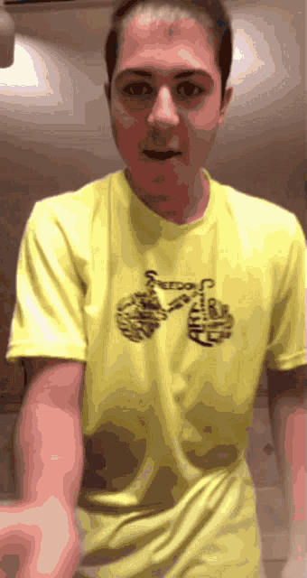 a man wearing a yellow t-shirt with the word freedom on it