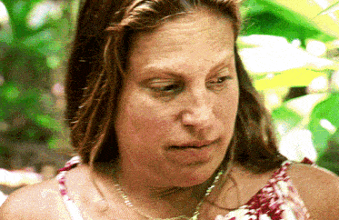 a close up of a woman 's face wearing a necklace
