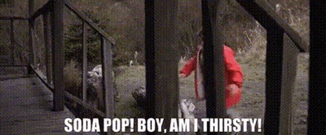 a person is standing on a set of stairs with the words soda pop boy am i thirsty written on the bottom .