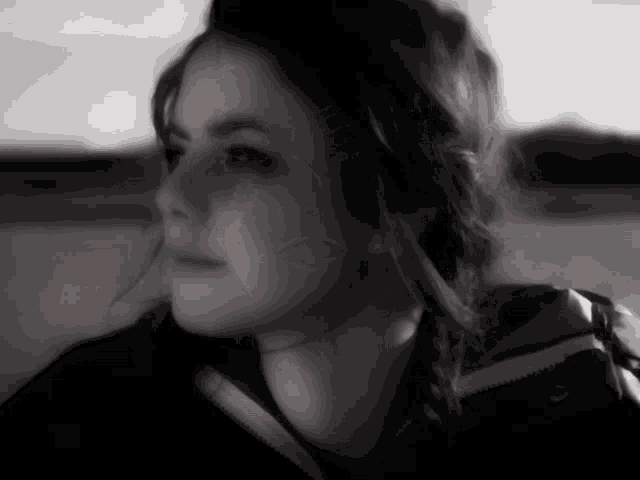 a black and white photo of a woman 's face and neck