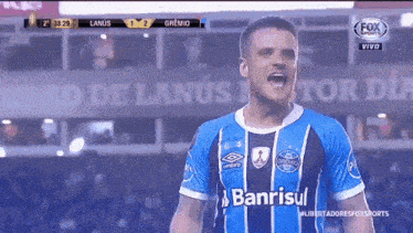 a soccer player wearing a blue and white uniform with banrisul on the front