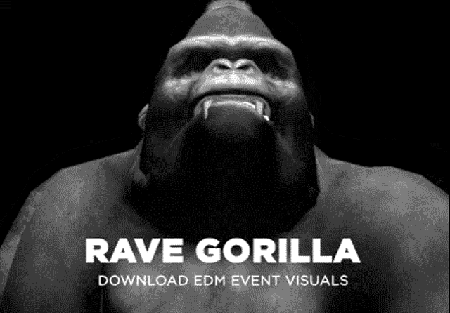 a black and white photo of a gorilla with its mouth open and teeth showing .