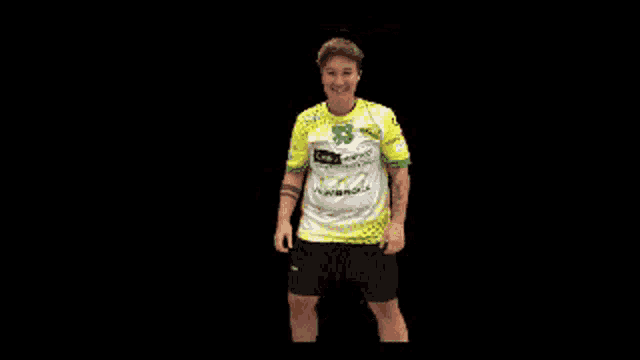 a man wearing a yellow and green shirt with the number 33 on it