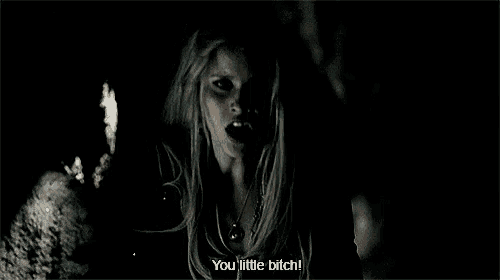 a woman in a witch costume is screaming in the dark .