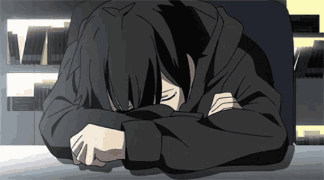 a person is laying down with their head on their arms