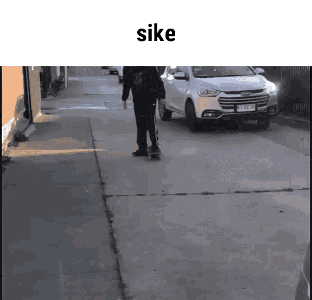 a person riding a skateboard on a sidewalk with the word sike on the top