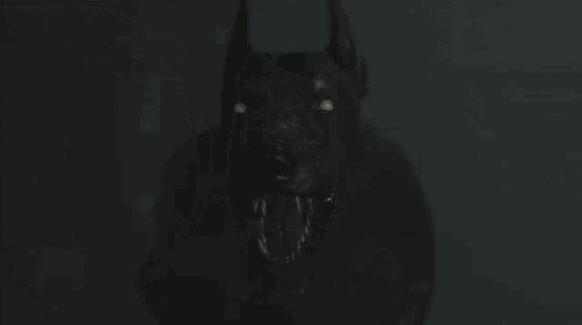 a man walking into a dark room with a sign that says exit on it