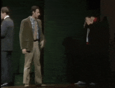 two men standing in front of a painting with the words " there 's just too much pressure in this line of work " below them