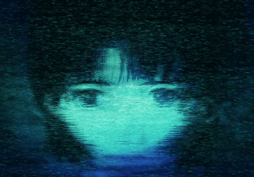 a blurry image of a person 's face with blue eyes