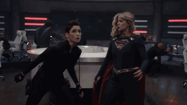 a woman in a superhero costume is standing next to a man