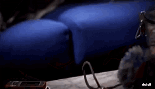 a blurry picture of a person laying on a blue pillow with the words rbd.gif below it