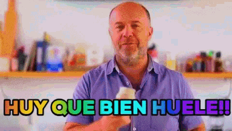a man in a purple shirt says " muy que bien huele " in spanish