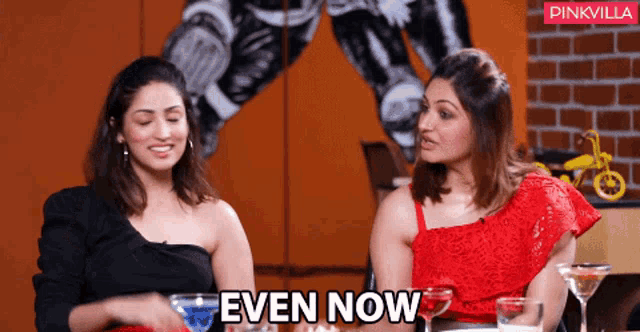 two women sitting next to each other with the words even now above them